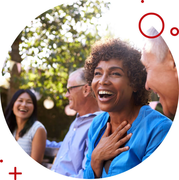 a group of older folks laughing outside