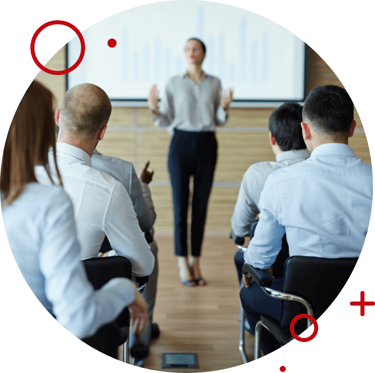 Teacher giving seminar in front of group of people