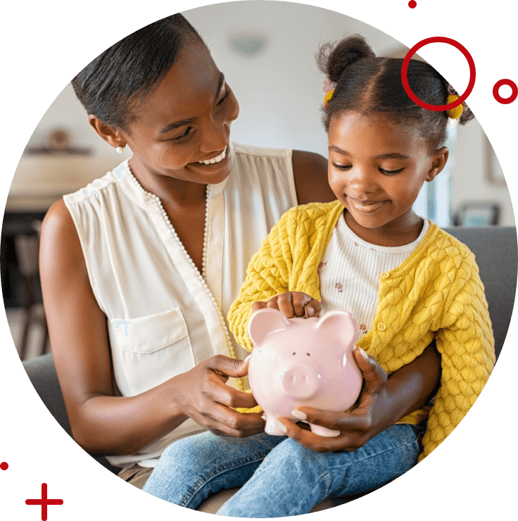 a mother and her daughter smiling holding a piggy bank