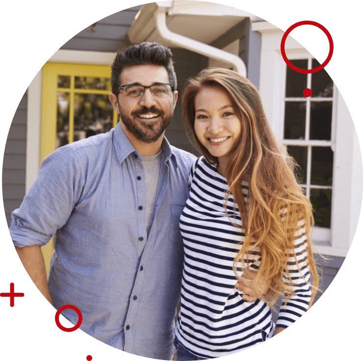 a couple smiling holding the keys to their new house