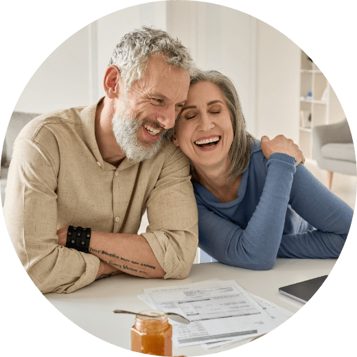 an older couple smiling at the table