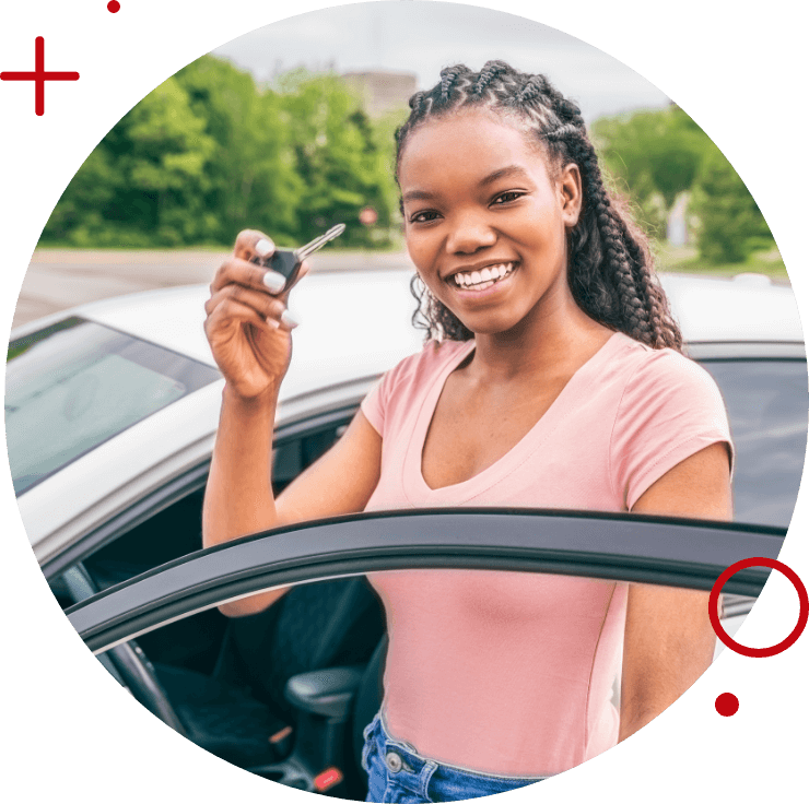 a young woman standing next to her car smiling and holding her car key