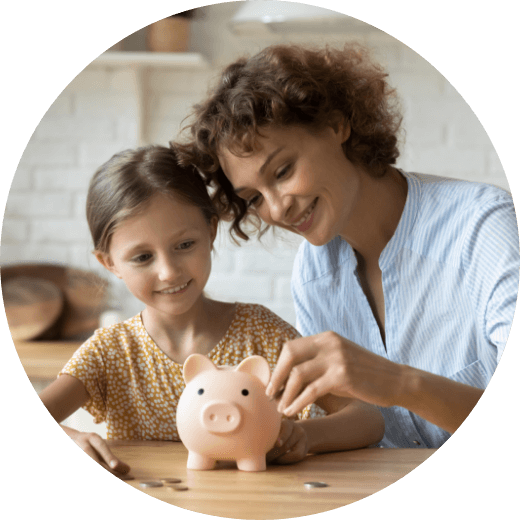 a mother and daughter putting coins in a piggybank