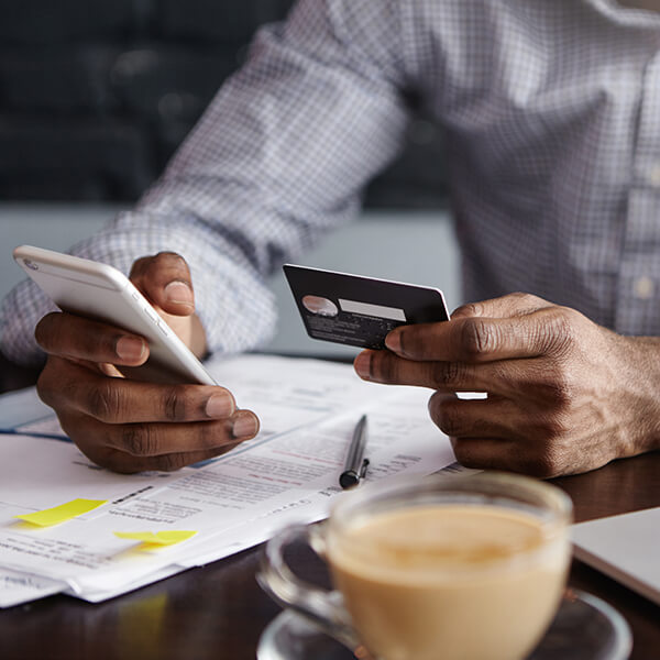 a man holding his credit card making payments