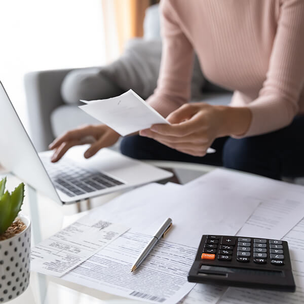 a woman doing bills on the computer