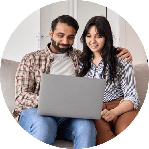 a man and a woman looking at their laptop