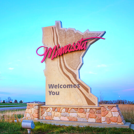 the stone "minnesota welcomes you" sign when you enter the state