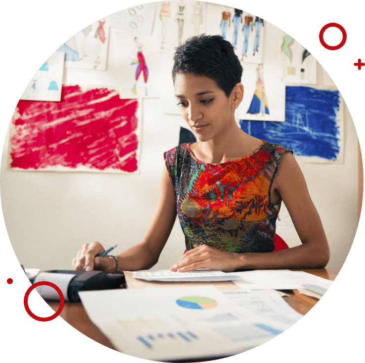 a woman looking at charts and using a calculator