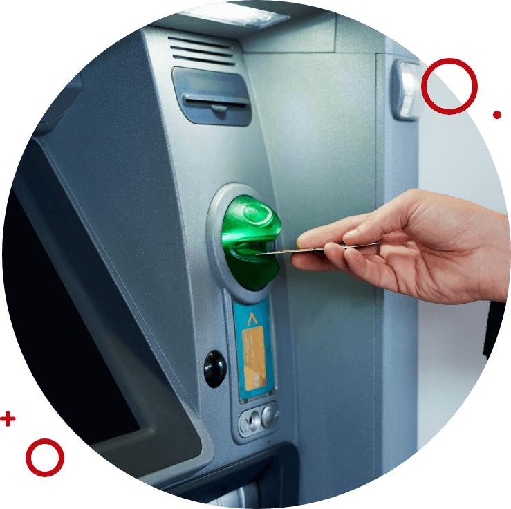 Hand inserting a debit card into an ATM machine